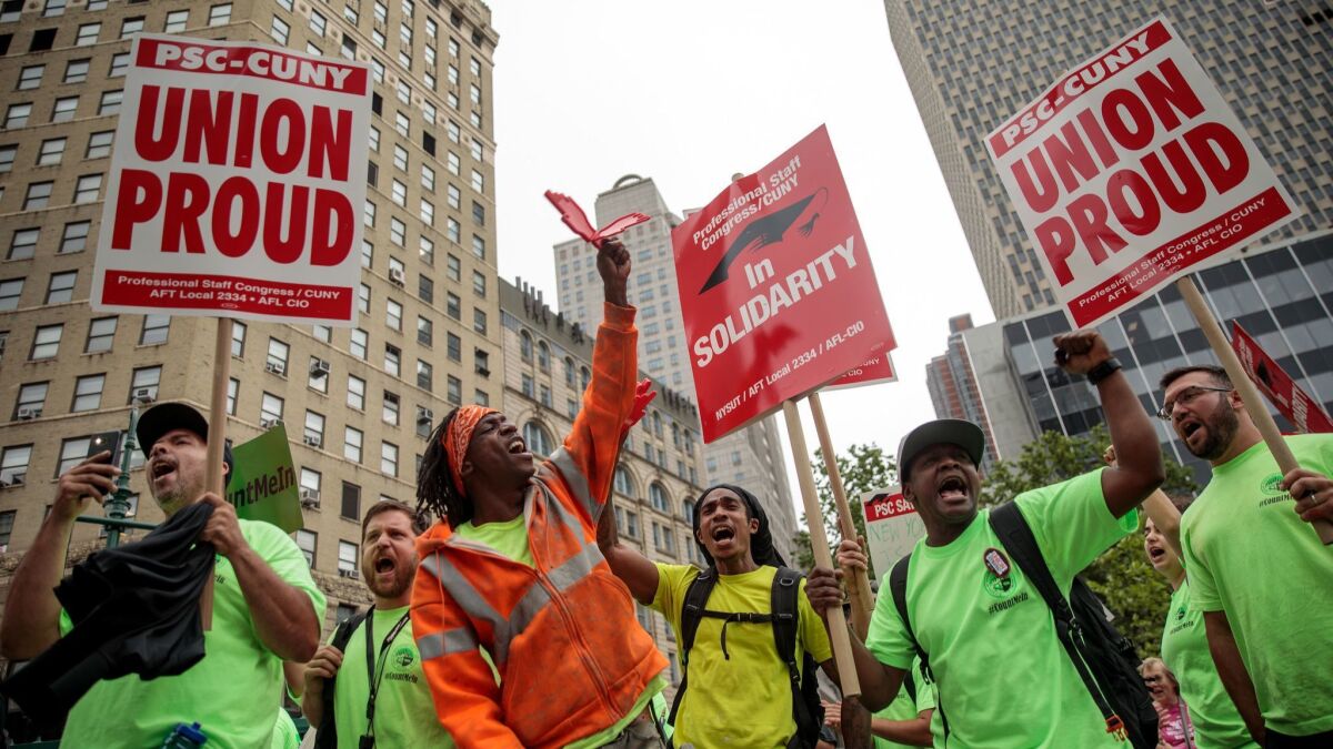 Union activists and supporters rally in June in New York City.