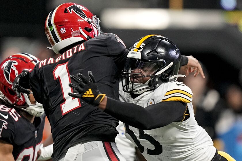 Atlanta Falcons quarterback Marcus Mariota (1) passes the ball as Pittsburgh Steelers linebacker Devin Bush (55) makes a hit during the second half of an NFL football game, Sunday, Dec. 4, 2022, in Atlanta. (AP Photo/Brynn Anderson)