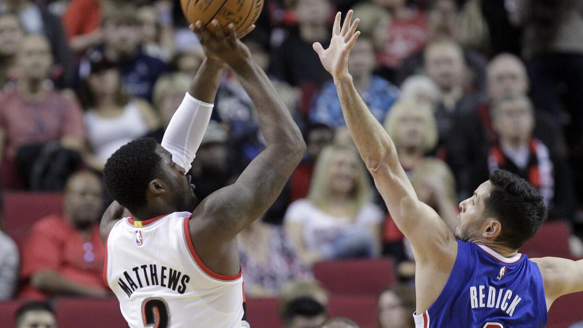 Portland Trail Blazers guard Wesley Matthews, left, shoots over Clippers guard J.J. Redick during the first half of the Clippers' preseason loss Sunday.