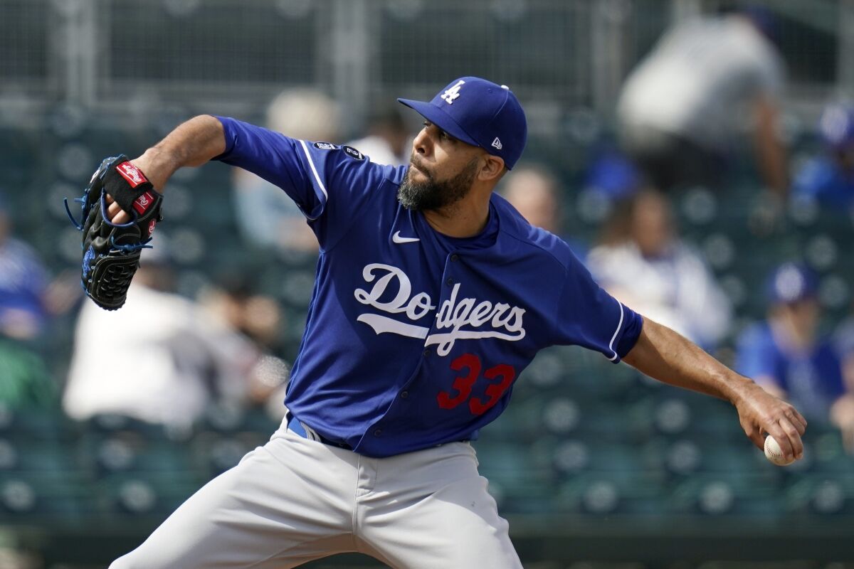 FILE - In this Friday, March 12, 2021, file photo, Los Angeles Dodgers pitcher David Price throws to a Cleveland Indians.