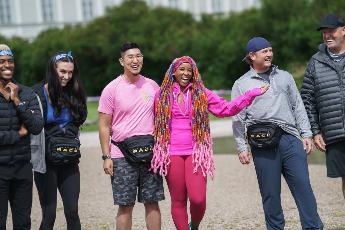 Richard Kuo and Dom Jones, center, are a team of motivational speakers on the new season of "The Amazing Race."