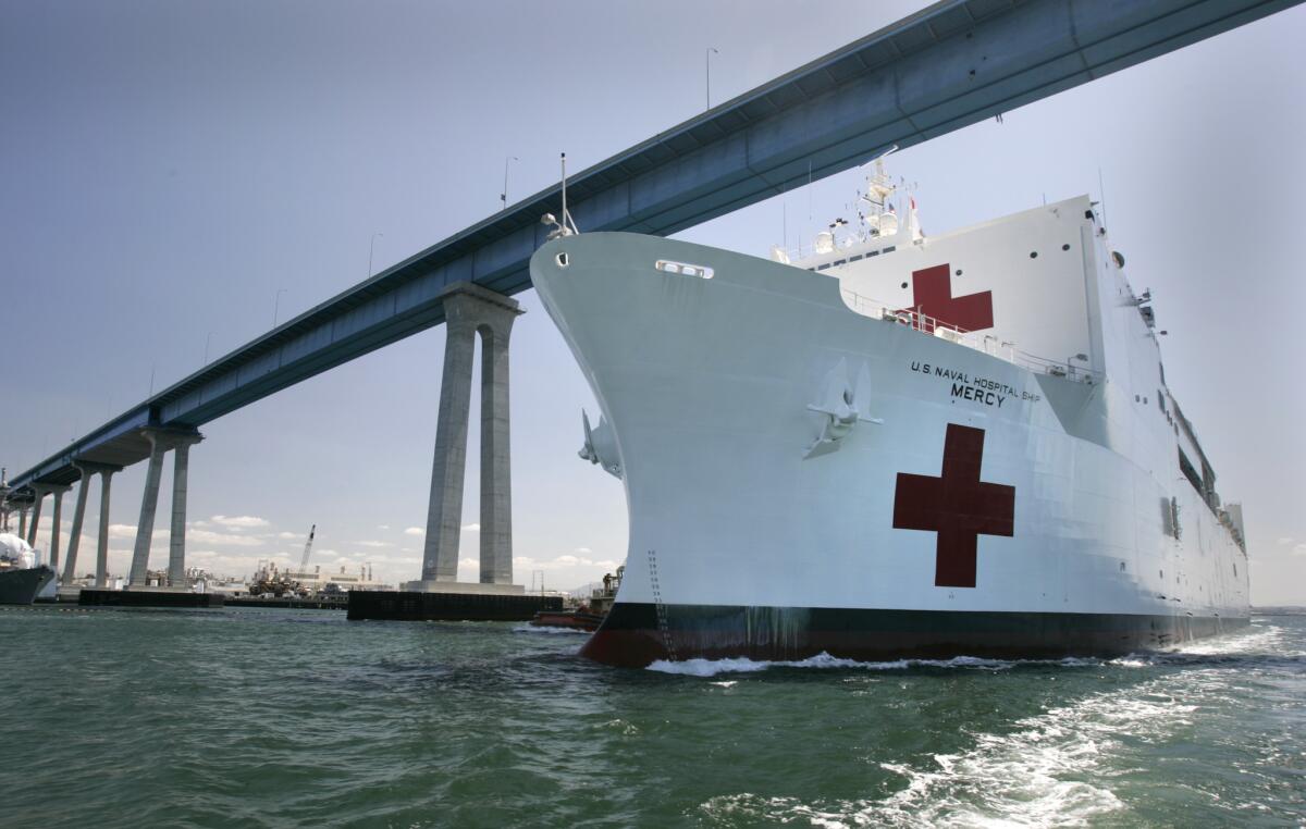 U.S. Naval Hospital Ship Mercy steams beneath the Coronado Bridge shortly after setting sail from the U.S. Naval Base San Diego.