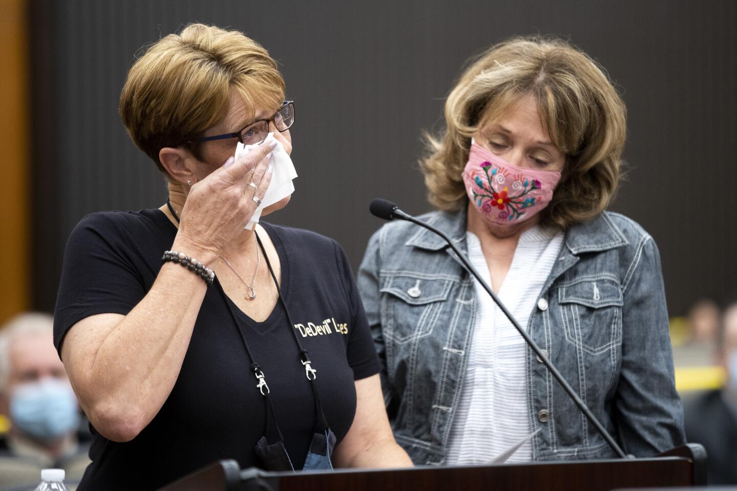 A woman wipes away tears in court.