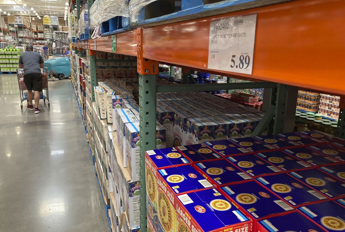 A shopper guides a cart past a line of gigantic boxes of breakfast cereals in a Costco warehouse on Thursday, June 17, 2021, in Lone Tree, Colo. Inflation at the wholesale level jumped 1% in June, pushing price gains over the past 12 months up by a record 7.3%. The Labor Department reported Wednesday, July 14 that the June increase in its producer price index, which measures inflation pressures before they reach consumers, followed a gain of 0.8% in May and was the largest one-month increase since January. (AP Photo/David Zalubowski)