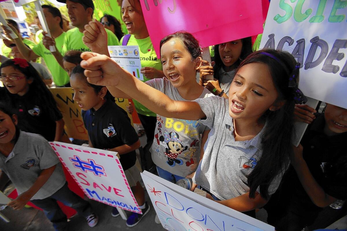 Makayla Bigler, 8, left, and Breeana Alano, 7, both going into the third grade, join a protest against the Los Angeles Unified School District's plan to shut down two charter schools.
