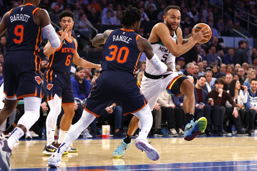 Minnesota Timberwolves forward Kyle Anderson (5) drives to the basket against New York Knicks forward Julius Randle (30) during the first half of an NBA basketball game, Monday, March 20, 2023, in New York. (AP Photo/Noah K. Murray)