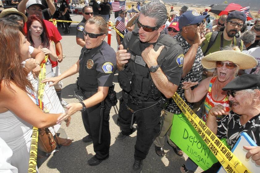 Crowds of protesters gather in front of the U.S. Border Patrol station in Murrieta in July, 2014, when protests forced away buses carrying immigrants apprehended at the Texas border.