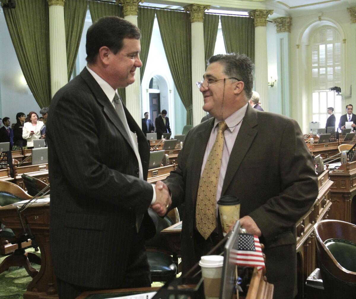 Assemblyman Donald Wagner, left, shakes hands with then-Assemblyman Anthony Portantino at the Capitol in 2011.