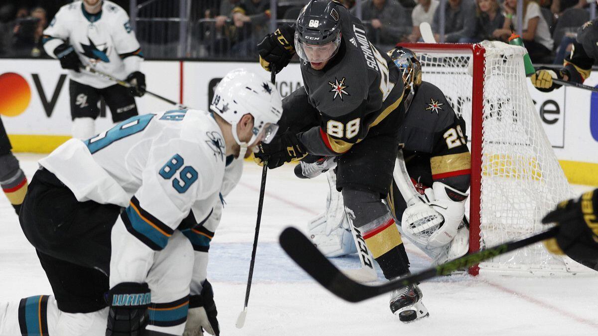 Vegas Golden Knights defenseman Nate Schmidt (88) vies for the puck with San Jose Sharks left wing Mikkel Boedker (89) during the second overtime of Game 2 of a second-round playoff series on Saturday.