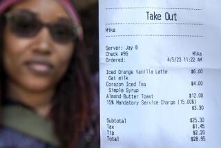 VENICE, CA-APRIL 5, 2023: Meeka Smith, 43, visiting from Baltimore, Maryland, shows her receipt that included a mandatory 15 percent service charge and a tip she left in addition to that for a take out order from a restaurant on Abbot Kinney Blvd. in Venice. (Mel Melcon / Los Angeles Times)