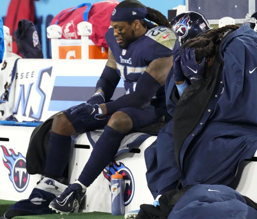 Tennessee Titans running backs Derrick Henry (22) and D'onta Foreman, right, sit on the bench after a loss to the Cincinnati Bengals in an NFL divisional round playoff football game, Saturday, Jan. 22, 2022, in Nashville, Tenn. (George Walker IV/The Tennessean via AP)