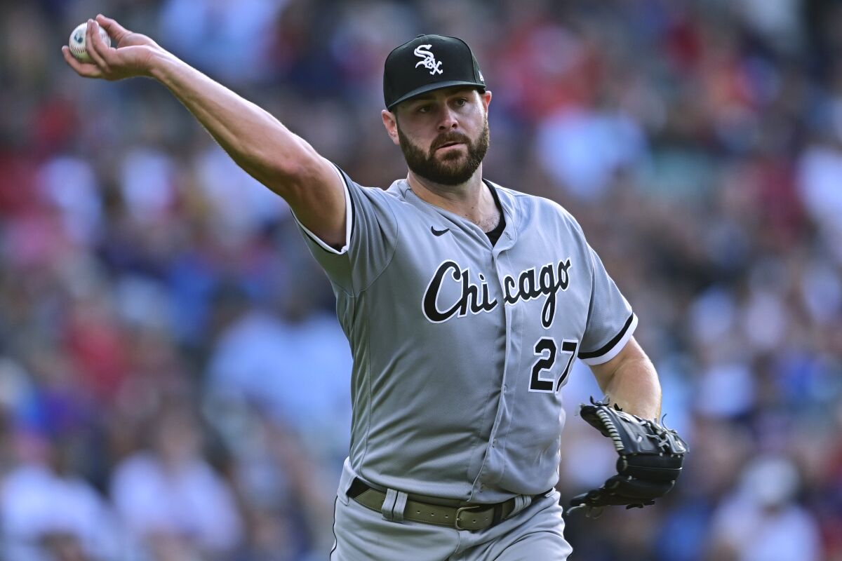 Chicago White Sox starting pitcher Lucas Giolito throw to first for the out on Cleveland Guardians' Austin Hedges during the third inning of a baseball game, Wednesday, July 13, 2022, in Cleveland. (AP Photo/David Dermer)