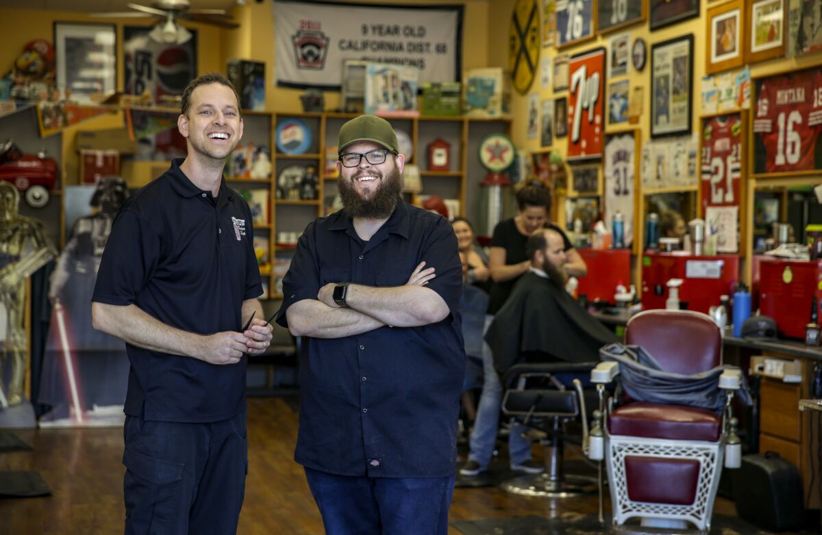 Mark Hylkema, left, and James Stewart, barbers and co-owners of Stews Barber Shop in Ladera Ranch, had to give employee status to barbers working as contractors after the California Supreme Court's Dynamex decision.