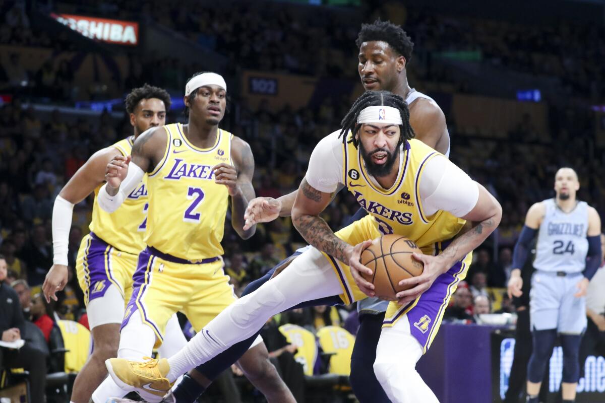 Lakers forward Anthony Davis pulls down a rebound during the first half Tuesday.
