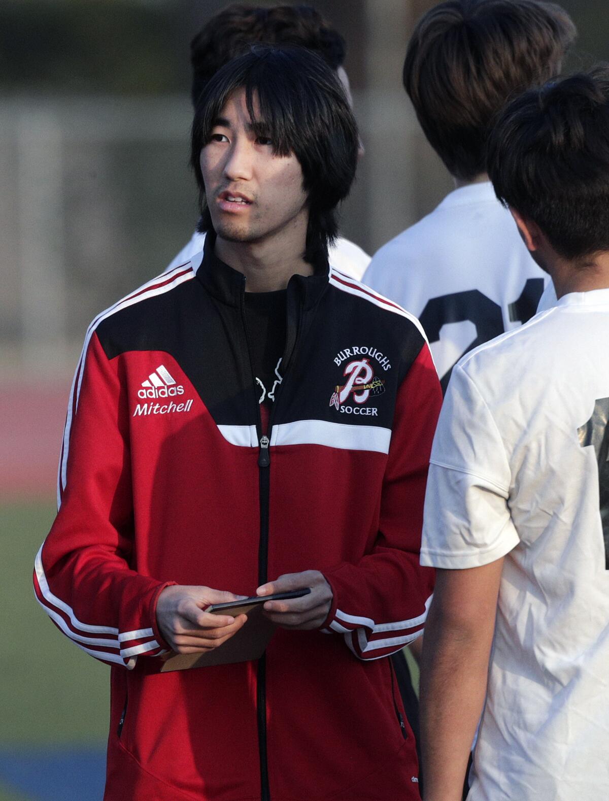 Burroughs' head coach Mitchell Kadoma talks with his team during halftime against Muir in a Pacific League boys' soccer game at Muir High School in Pasadena on Tuesday, January 14, 2020.