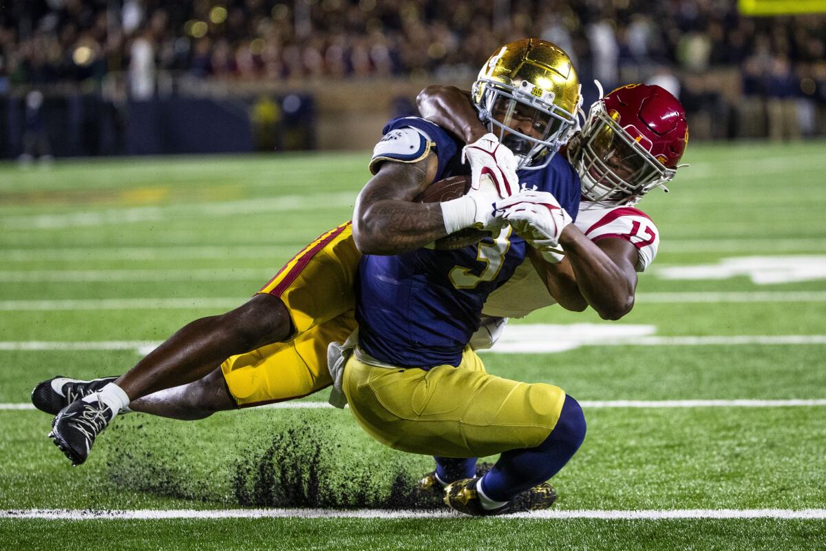 Notre Dame running back Gi'Bran Payne scores a touchdown as USC cornerback Christian Roland-Wallace tries to tackle him