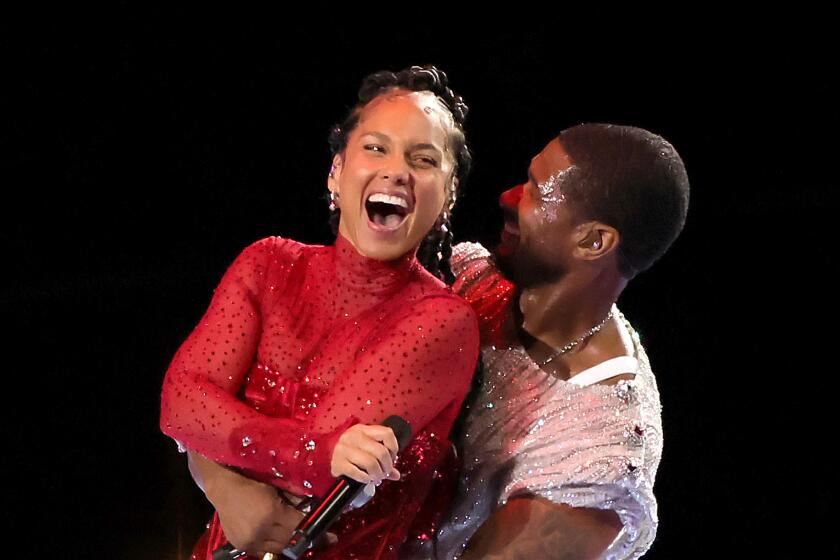 Alicia Keys and Usher perform onstage during the 2024 Super Bowl halftime show