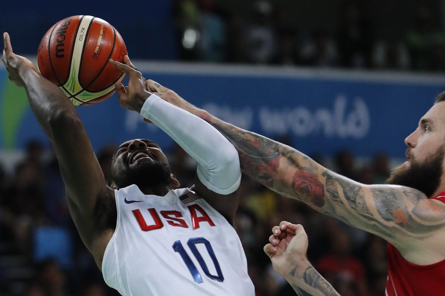 USA's Kyrie Irving (L) and Serbia's Miroslav Raduljica in action during the men's preliminary round match between the USA and Serbia for the Rio 2016 Olympic Games Basketball tournament at the Carioca Arena 1 in the Olympic Park in Rio de Janeiro, Brazil.