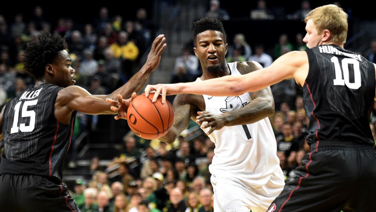 Oregon guard Jordan Bell tries to pass the ball between Stanford's Marcus Allen (15) and Michael Humphrey (10) during the first half Saturday.