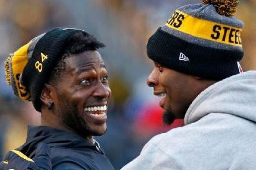 Steelers wide receiver Antonio Brown, left, and running back Le'Veon Bell celebrate on the sideline after a Steelers touchdown during the second half of a game against the Cleveland Browns on Jan. 1.