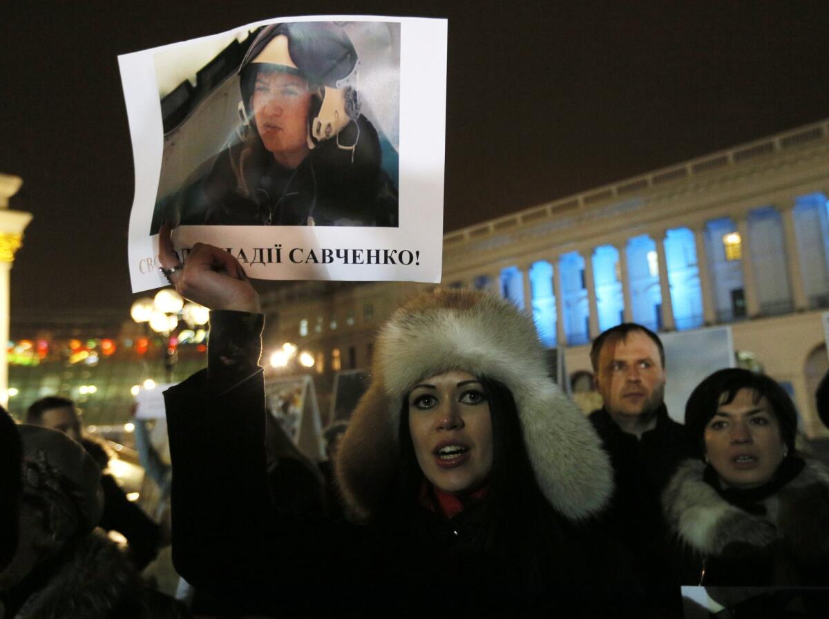 A woman holds a poster of captured Ukrainian army officer Nadezhda Savchenko at a rally in Kiev on Jan. 26.