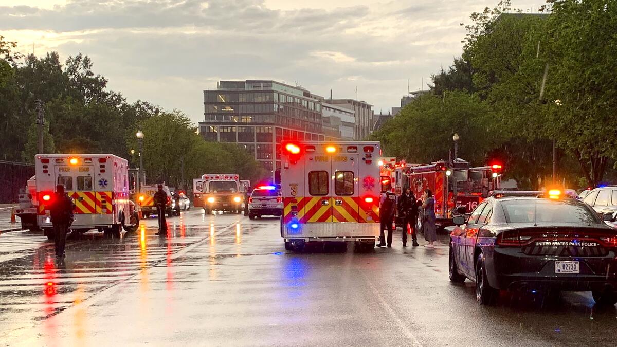 In this photo provided by @dcfireems, emergency medical crews are staged on Pennsylvania Avenue between the White House and Lafayette Park, Thursday evening, Aug. 4, 2022 in Washington. Two people who were critically injured in a lightning strike in Lafayette Park outside the White House have died, police said Friday. Two others remained hospitalized with life-threatening injuries. (@dcfireems via AP)