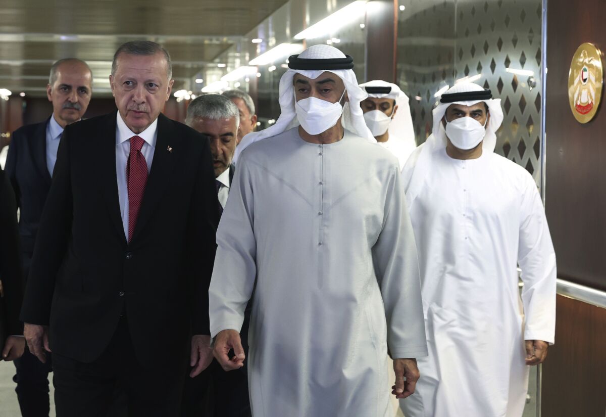 Turkish President Recep Tayyip Erdogan, left, and Sheikh Mohammed bin Zayed Al Nahyan, center, walk before a meeting in Abu Dhabi, United Arab Emirates, Tuesday, May 17, 2022. Erdogan travelled to Abu Dhabi Tuesday to offer his condolences on the death of the United Arab Emirates' late ruler and meet with the federation's newly ascended president. Erdogan met with Sheikh Mohammed bin Zayed Al Nahyan, who ascended the presidency following the death of Sheikh Khalifa bin Zayed Al Nahyan. (Turkish Presidency via AP)