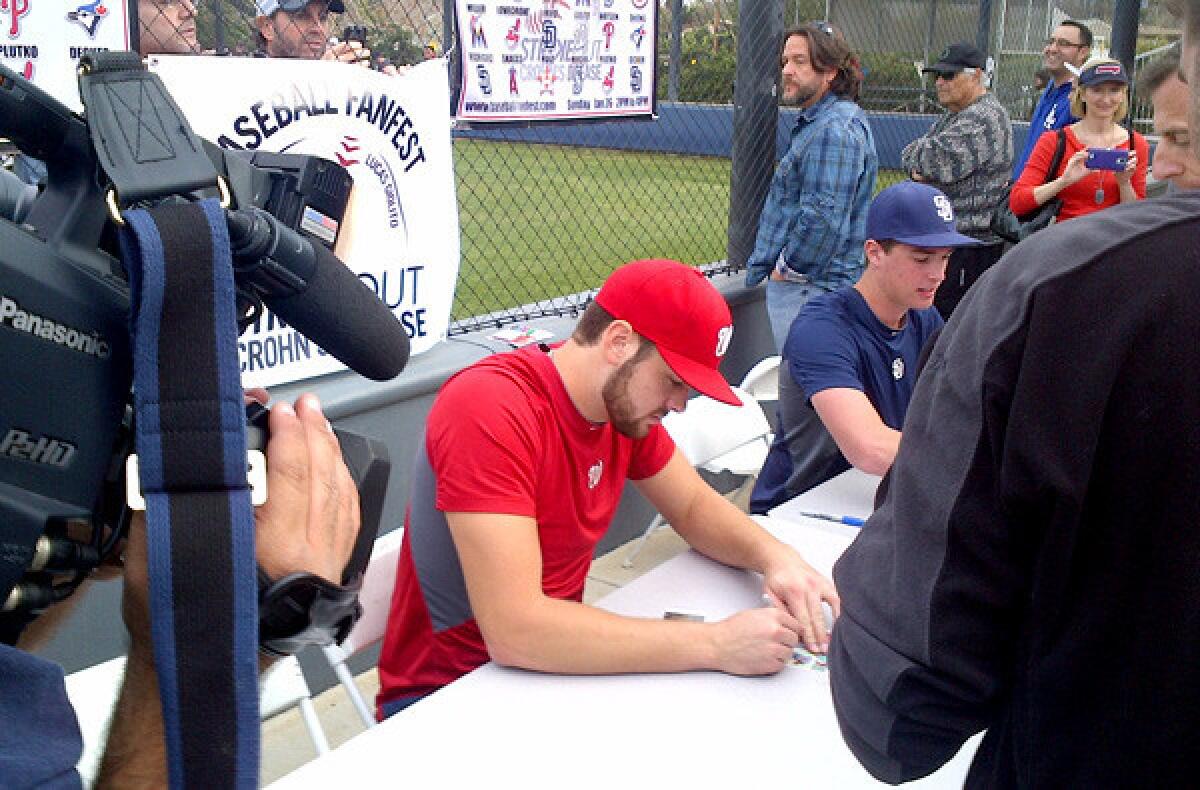 Former Harvard-Westlake pitcher and Nationals prospect Lucas Giolito signs autographs on Sunday.