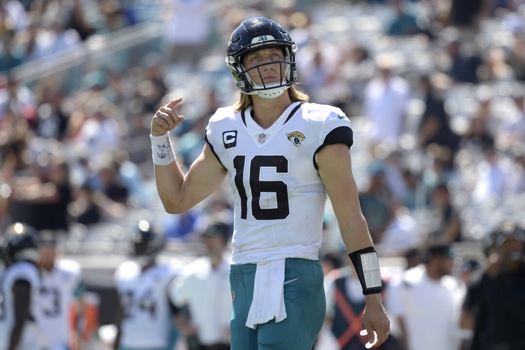 Jacksonville Jaguars quarterback Trevor Lawrence views the stadium video monitor before a play.