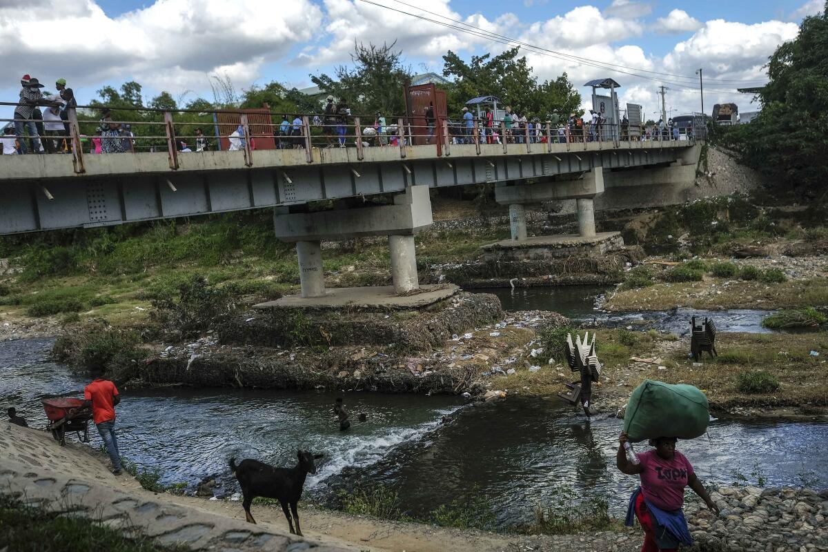 People bathe in the Massacre River on the border with Haiti in Ouanaminthe, Dominican Republic