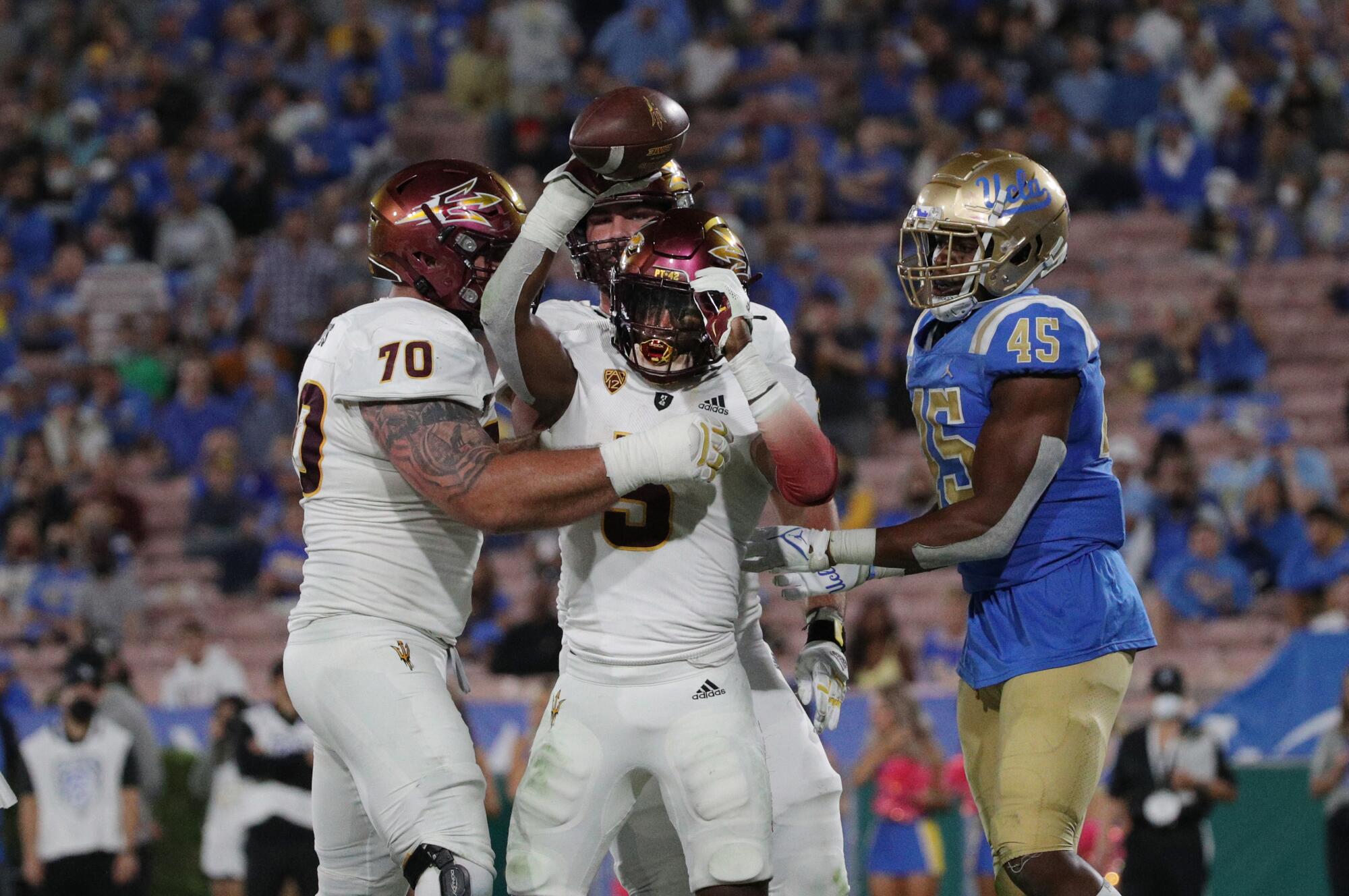 Arizona State running back Rachaad White celebrates with offensive lineman Henry Hattis.