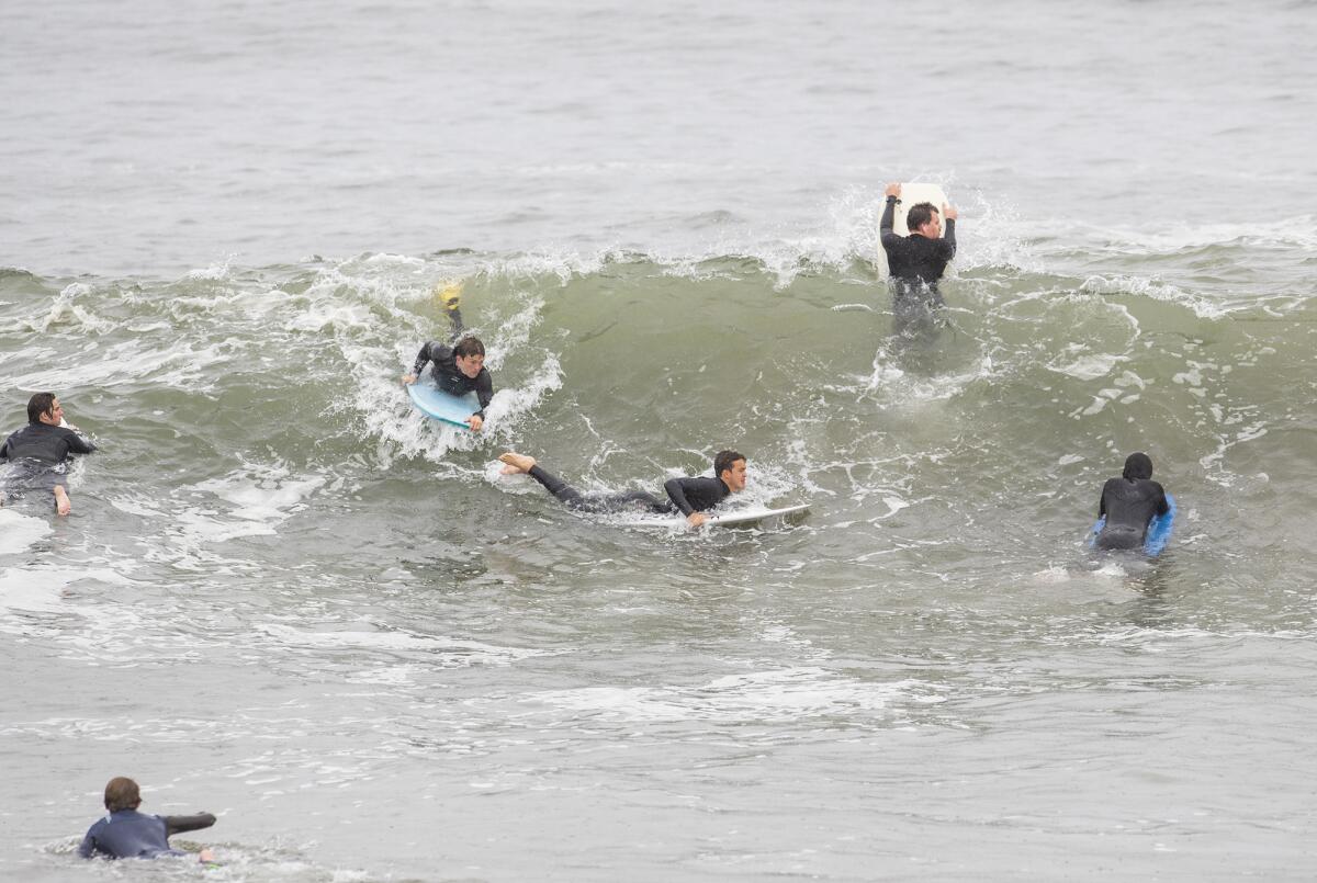 Surfers and boogie boarders angle for position at the Wedge in Newport Beach on Thursday.