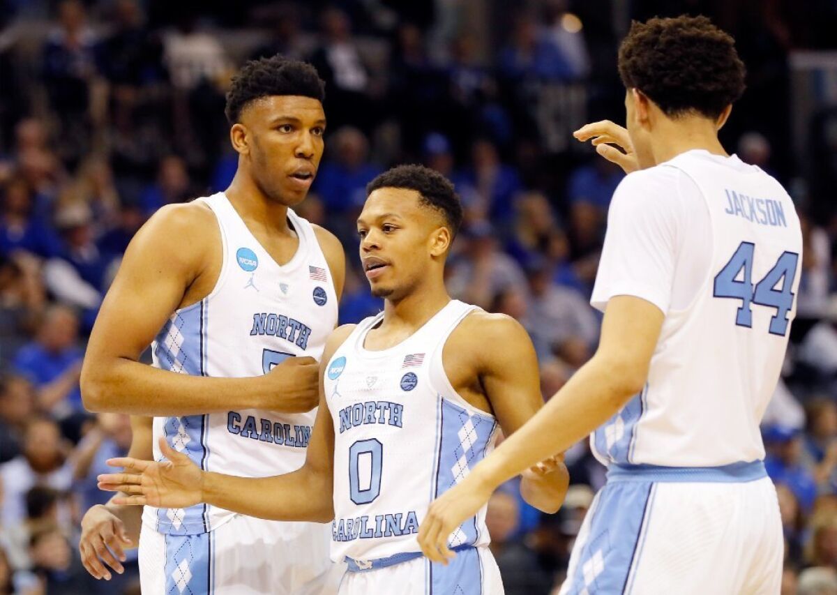 North Carolina's Nate Britt (0) celebrates with his teammates Tony Bradley (5) and Justin Jackson (44) during the second half of a Sweet 16 game against Butler on March 24.