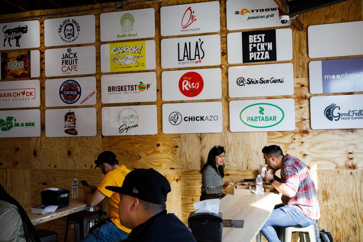 UCLA students Radhika Sakalkale and Bobby Bastin, right, eat Main Chick Hot Chicken sandwiches at Colony.