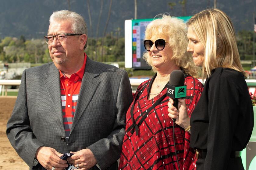 Owners Pierre and Leslie Amestoy get ready to be interviewed by Santa Anita Park's Millie Ball.