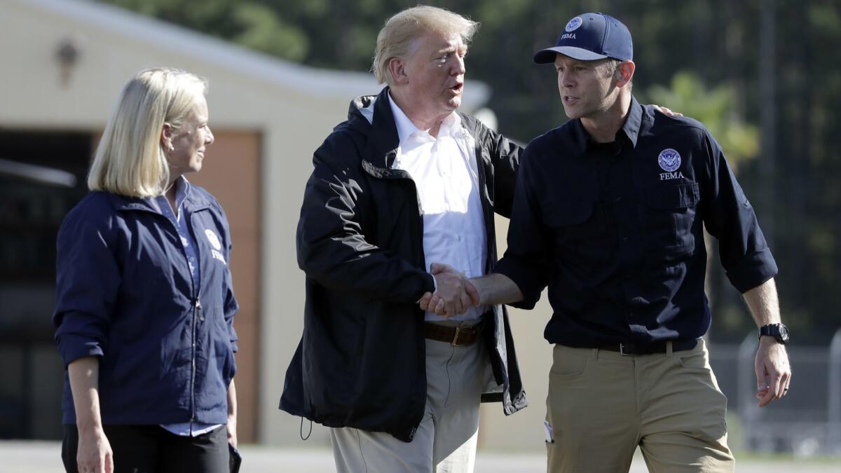 President Trump shakes hands Sept. 19 with FEMA Administrator Brock Long as Homeland Security Secretary Kirstjen Nielsen watches in Myrtle Beach, S.C.