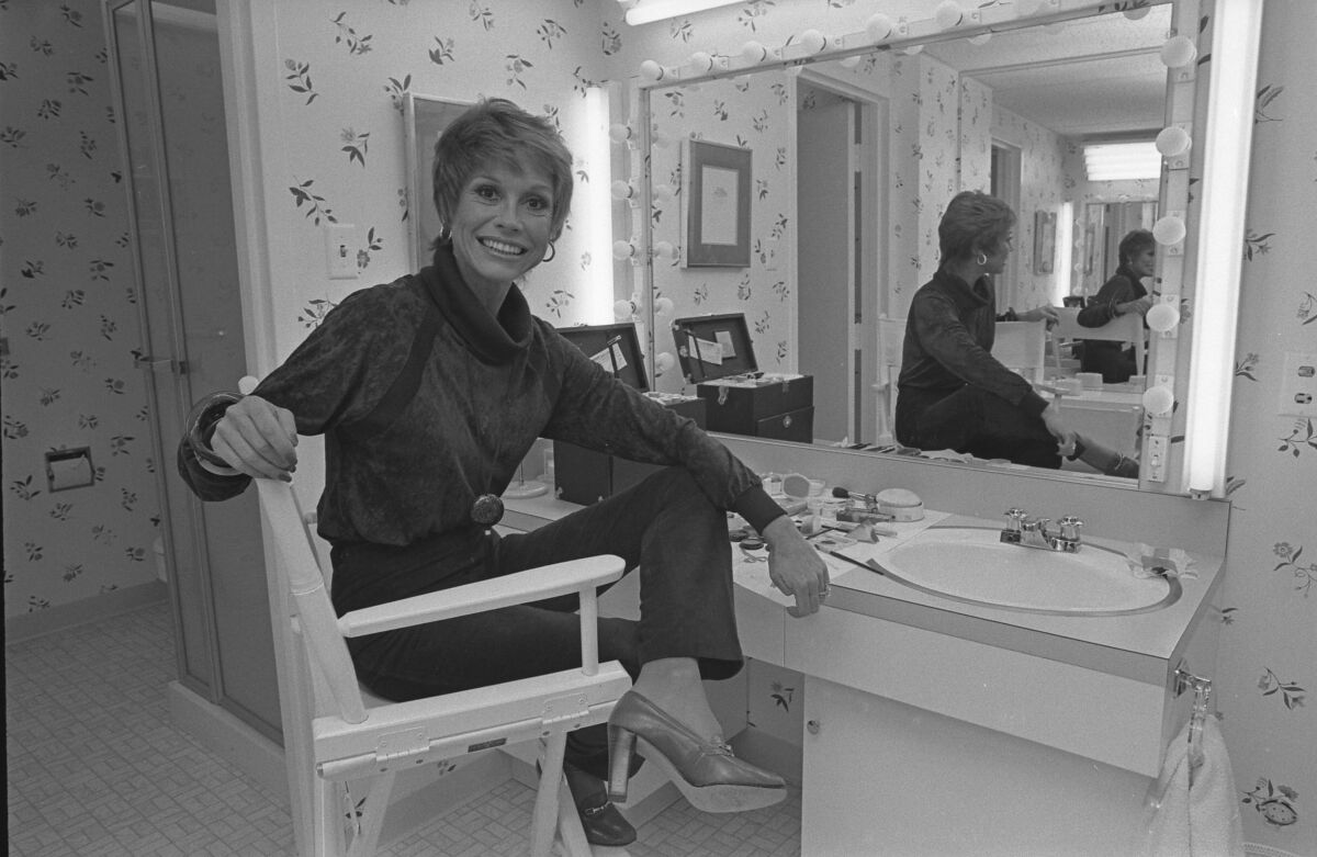 Actress Mary Tyler Moore sitting in front of a dressing room table in 1978.
