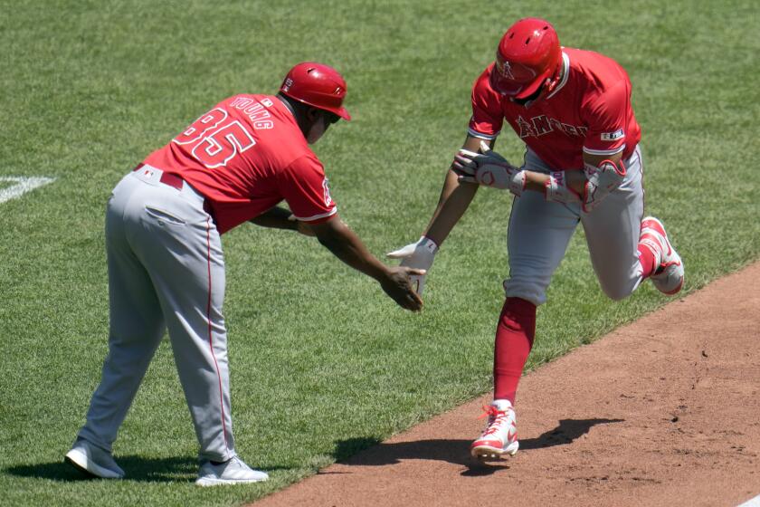 Los Angeles Angels' Jo Adell, right, is greeted by third base coach Eric Young Sr. as he rounds third after hitting a solo home run off Pittsburgh Pirates starting pitcher Martín Pérez during the third inning of a baseball game in Pittsburgh, Wednesday, May 8, 2024. (AP Photo/Gene J. Puskar)