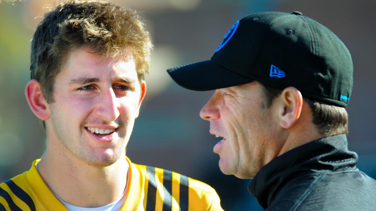 UCLA quarterback Josh Rosen listens to Coach Jim Mora following a spring practice on March 29.