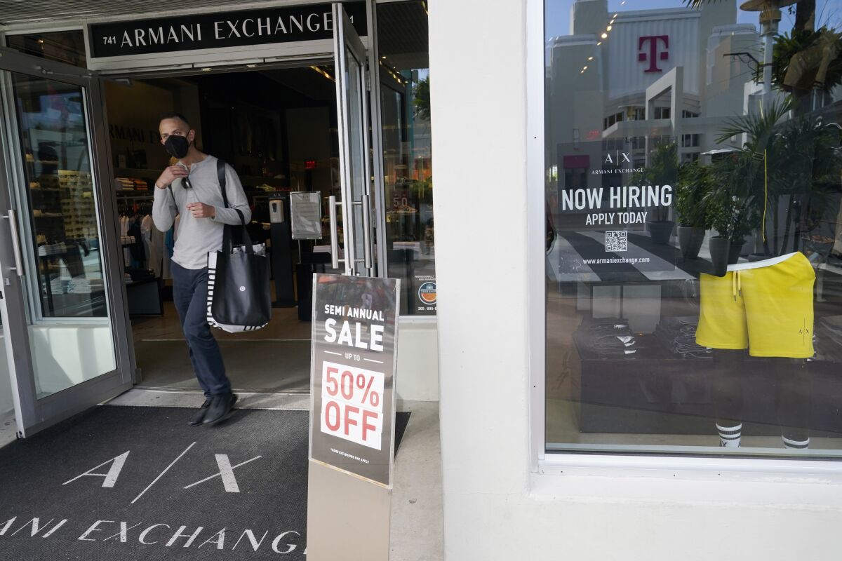 FILE - A shopper walks out of an Armani Exchange store, Jan. 21, 2022, in Miami Beach, Fla. U.S. consumers grew more confident for the second month in a row as gas prices continued to fall. The Conference Board said Tuesday, Sept. 27, 2022 that its consumer confidence index rose to 108 in September, from 103.6 in August. The back-to-back monthly increases follow three straight monthly declines as American households were hammered by rising prices, particularly at the gas pump. (AP Photo/Marta Lavandier)