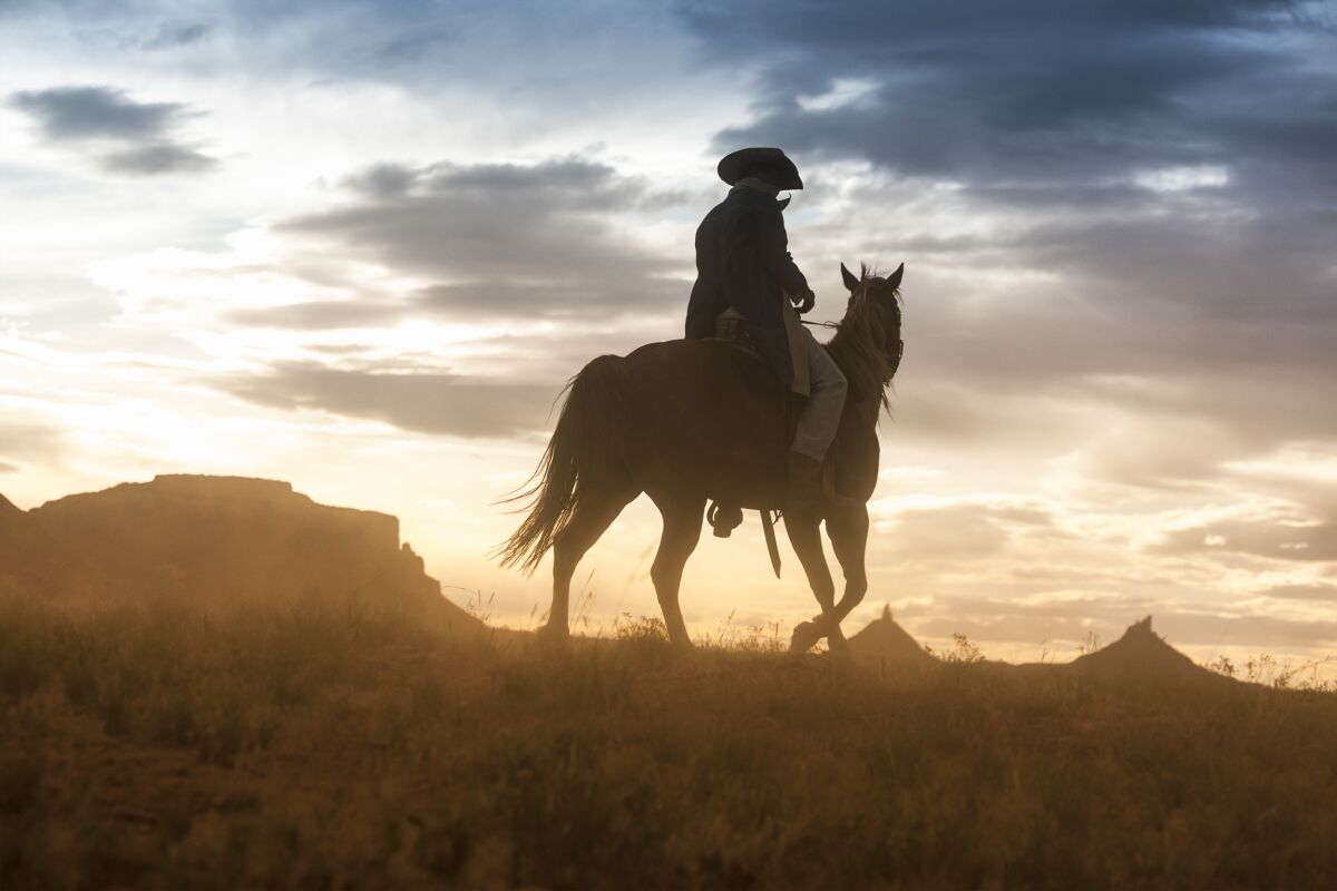 The Jim Krantz photograph "Epic Western No. 48": the silhouette of a horse-riding cowboy, mountains in the distance.