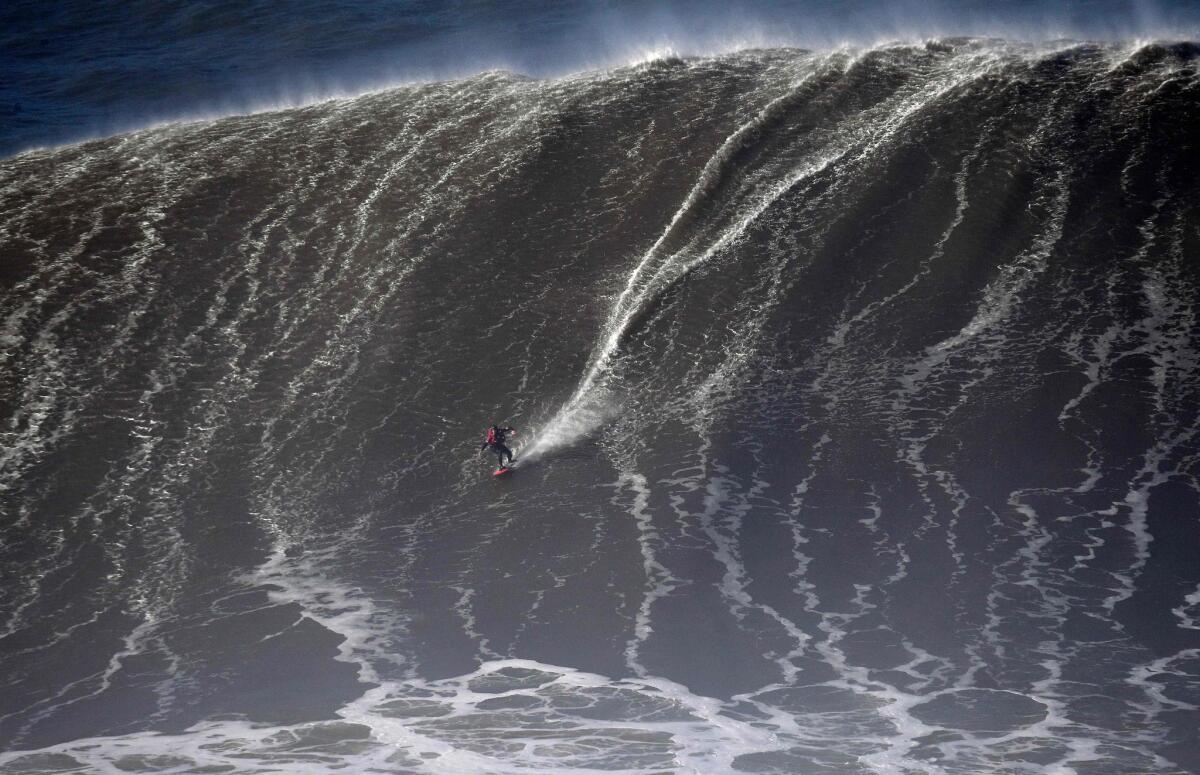 Joao Guedes rides a large wave during a surf session in Portugal