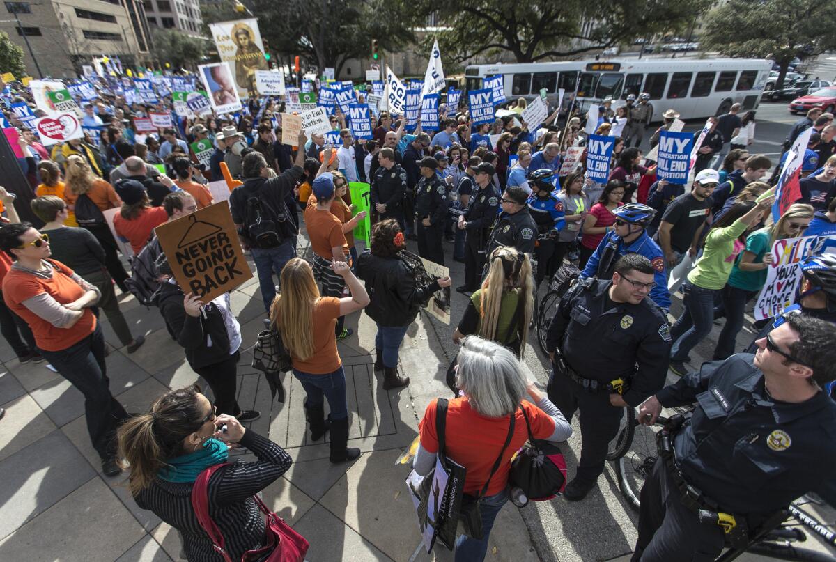 Thousands of anti-abortion Texans march to the Texas State Capitol, where they were met by an abortion rights advocacy group. Two more abortion clinics closed in Texas on Thursday because of restrictions in a state law.