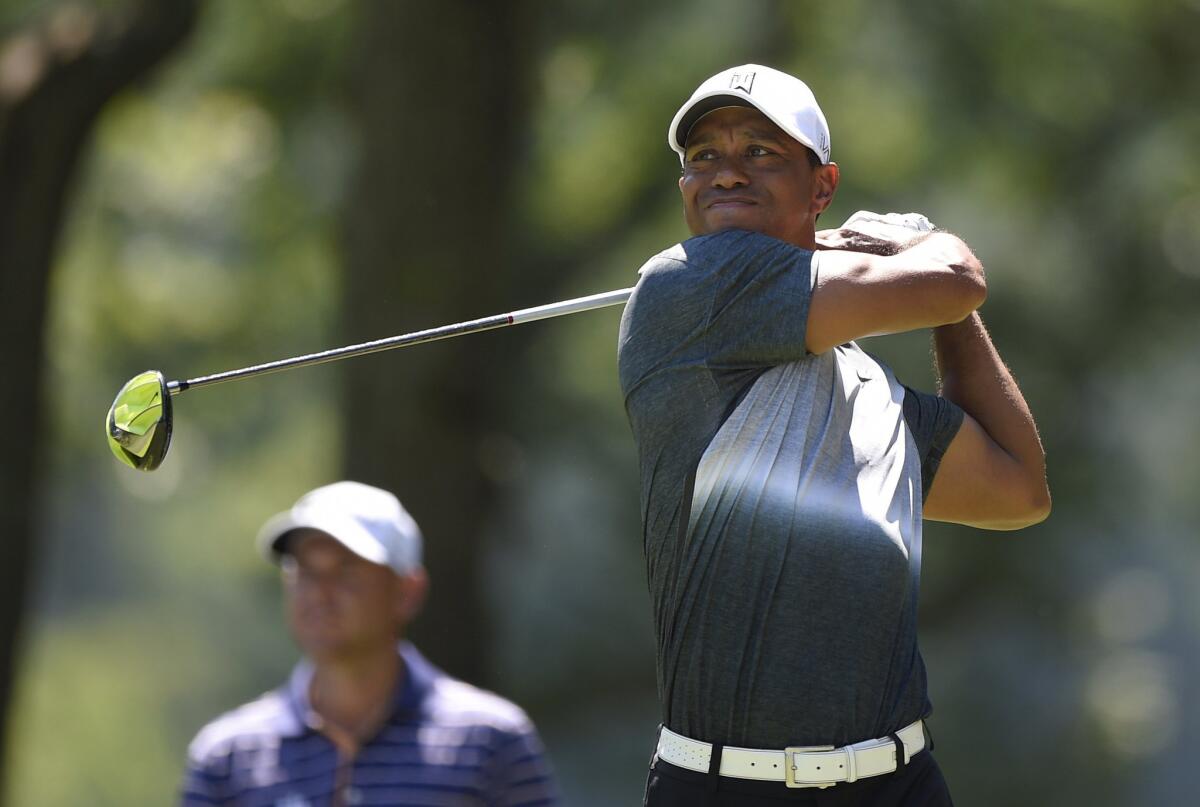Tiger Woods watches his shot on the fifth tee during the second round of the Quicken Loans National golf tournament on Friday at the Robert Trent Jones Golf Club in Gainesville, Va.