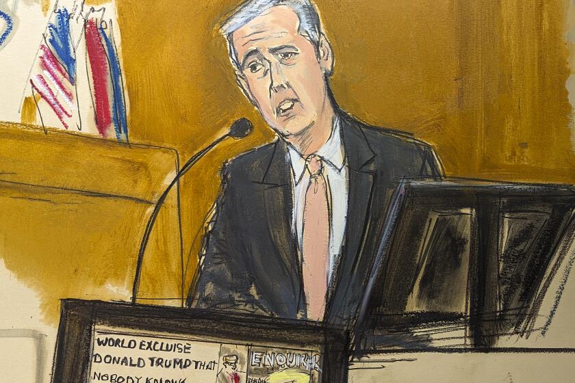 Michael Cohen testifies on the witness stand with a National Enquirer cover story about Donald Trump displayed on a screen in Manhattan criminal court, Monday, May 13, 2024, in New York. (Elizabeth Williams via AP)