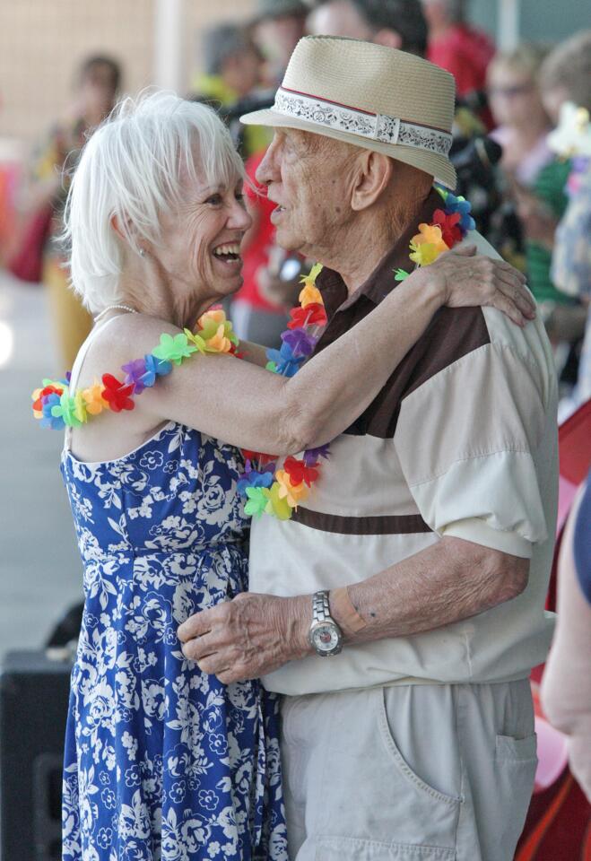 Linette Prutz and Larry Radulsai, who had just met in November and have been dating since, embrace after dancing at Verdugo Pool for the first ever "Rock-a-Hula" pool party for local seniors in Burbank on Thursday, August 21, 2014. The idea came from a Burbank City Council meeting from Vice Mayor Bob Frutos, and it was a great success with nearly 200 seniors who came to play.