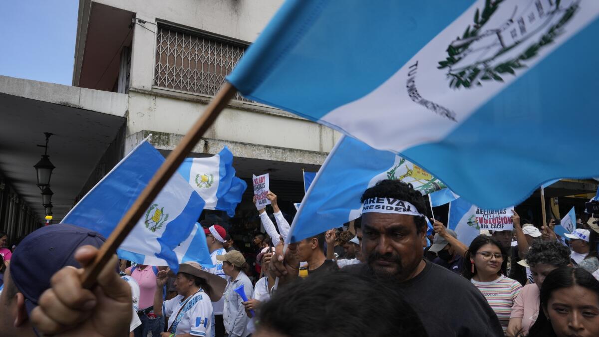 Demonstrators wave flags in Guatemala.