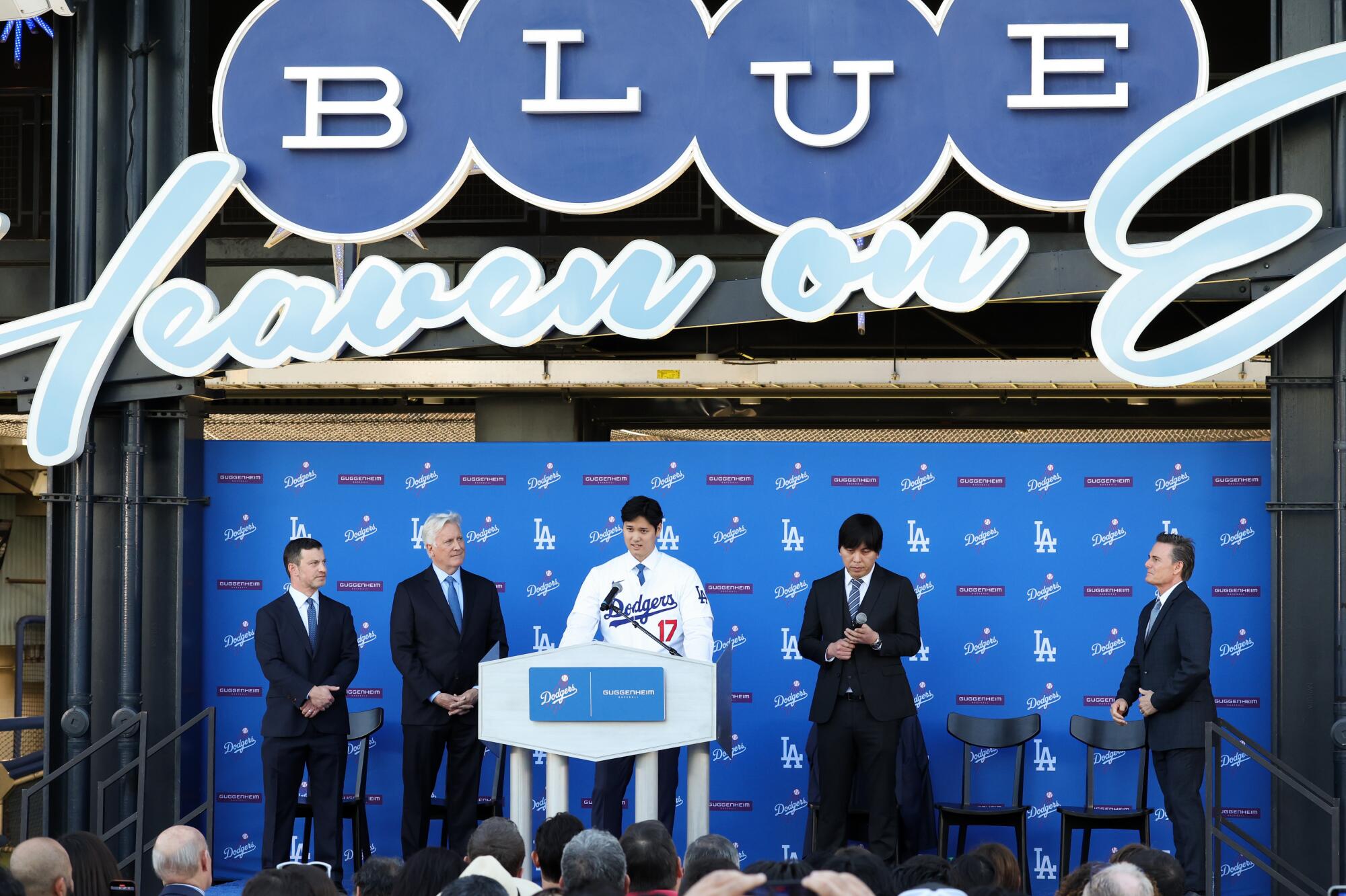 Shohei Ohtani, center, speaks on the stage during his introductory news conference at Dodger Stadium on Dec. 14.
