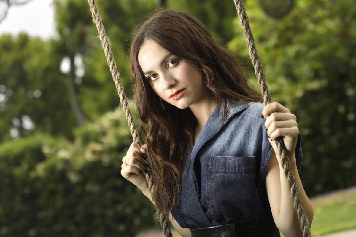 Judd Apatow's daughter Maude Apatow outside on a swing.