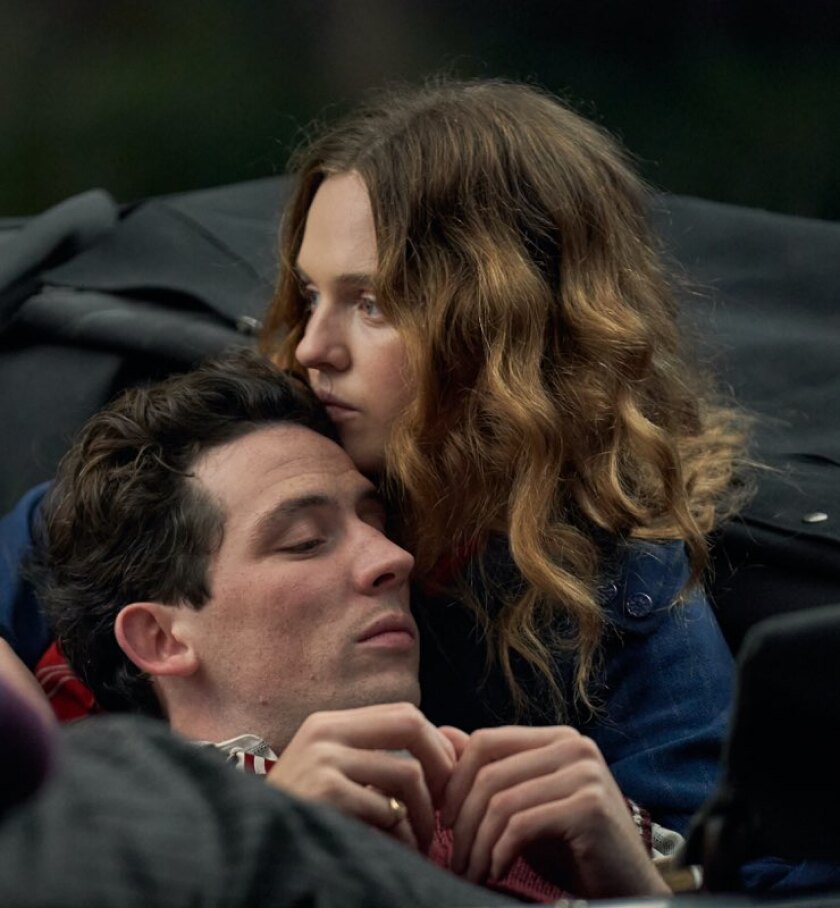 A man leans his head against a woman's shoulder.